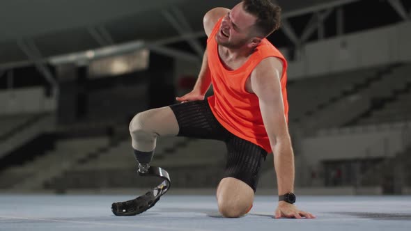 Caucasian disabled male athlete with running blade suffering from exhaustion