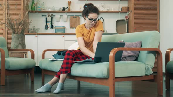 Pretty Lady in Leisure Wear Is Working on a Computer