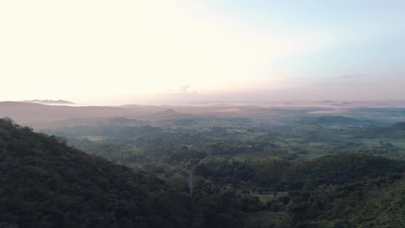 Drone footage of two small mountains during sunrise