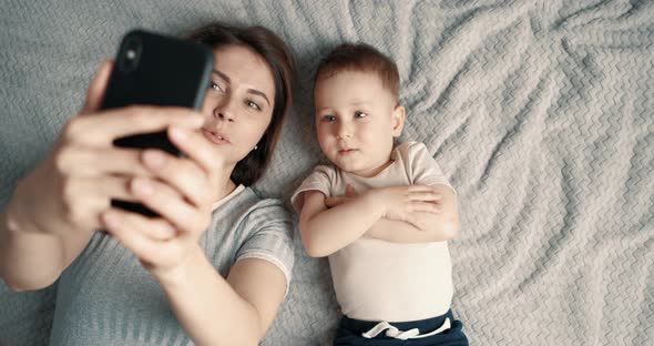 Mom and Son Take Selfies Using Mobile Phone