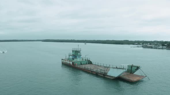 Aerial footage, circling around an old and rusty ferry 