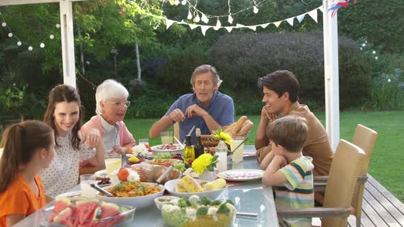 Family eating outside together in summer