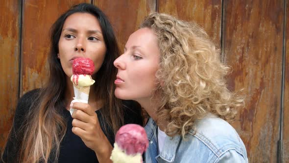 Funny Female Friends Eating Ice Cream In Summer Outdoors