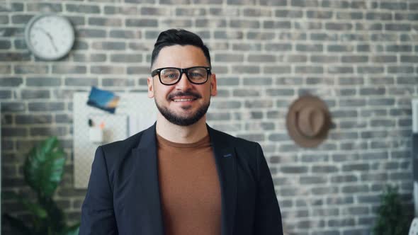 Portrait of Successful Businessman Smiling Looking at Camera in Office