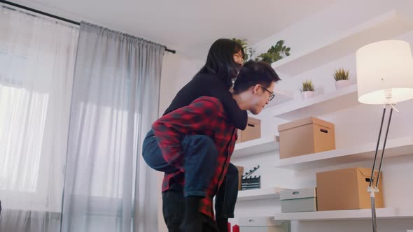 Happy Young Asian Couple in New Appartment