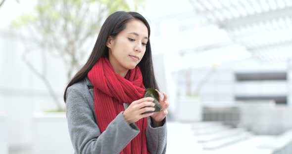 Woman eating Japanese rice dumpling at outdoor