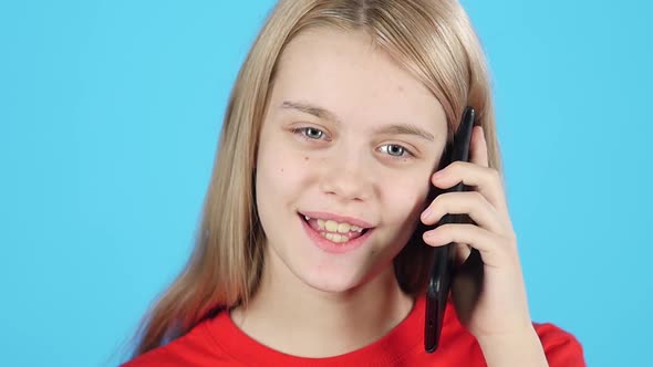 Close-up of Pretty Girl Talking on the Phone. Slow Motion