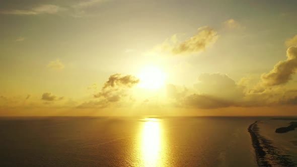 Aerial travel of exotic tourist beach trip by aqua blue sea with white sand background of a daytrip 