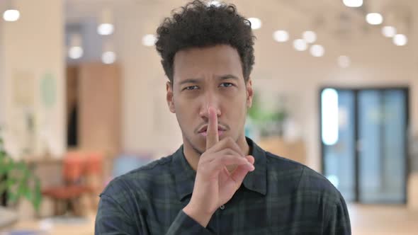 African American Man Showing Quiet Sign Finger on Lips