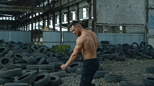 Shirtless bodybuilder in abandoned place