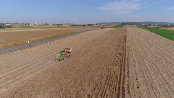 Drone Flight over Agricultural Fields and Wheat Fields being Harvested by Amish Farmer and Horse