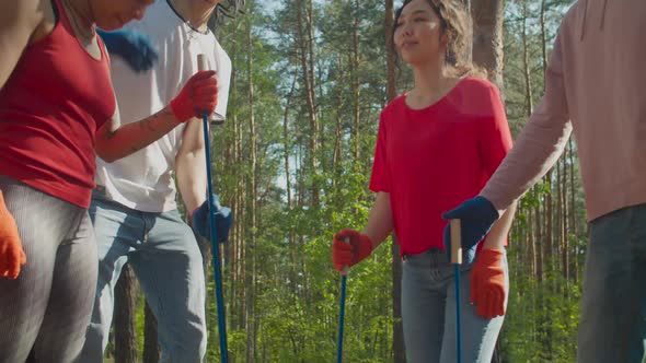 Diverse Volunteer Team Giving High Five in Nature