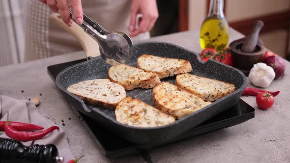 Toasting Slices of Baguette in a Grill Frying Pan