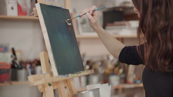 Woman Artist Painting in Studio