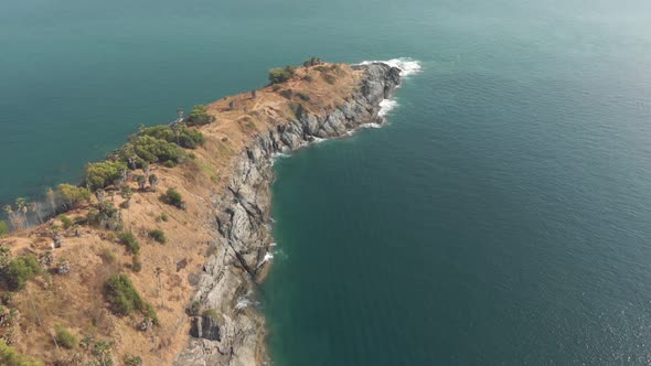 View of Promthep Cape, southern most tip of Phuket, Thailand - Aerial Tilt-up Reveal shot