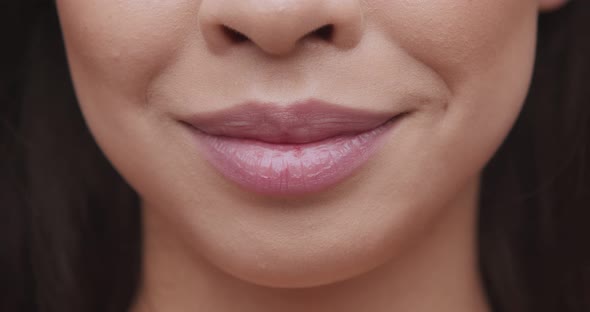 Close Up of Female Smiling Lips with Pink Lipgloss