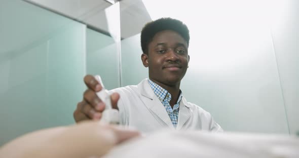 Portrait of Young Professional Male African American Doctor Obstetrician Using