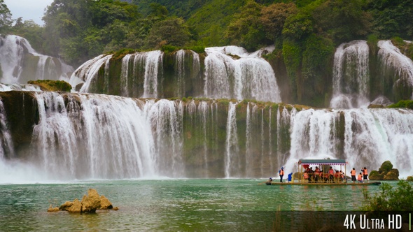 4K Panoramic Ban Gioc Waterfall In Vietnam With Boat of Tourists