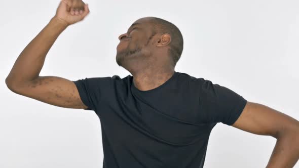 Young African Man Dancing in Joy on White Background