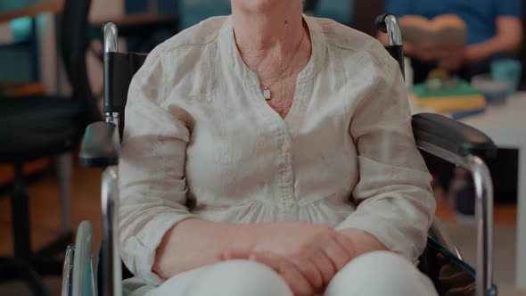 Portrait of Elderly Woman Sitting in Wheelchair at Home