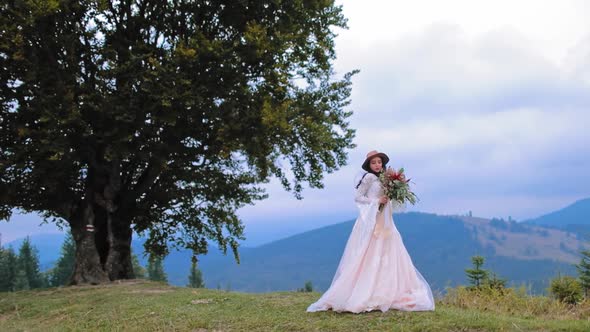 Beautiful bride on mountain. Wedding shot of young bride at mountains with amazing view