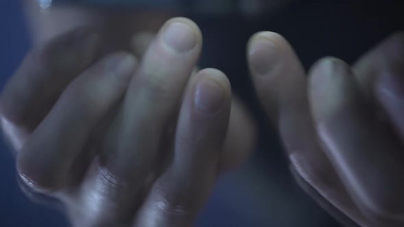 Male Fingers Sliding Pages and Typing on Smartphone, Reflection in Glossy Table