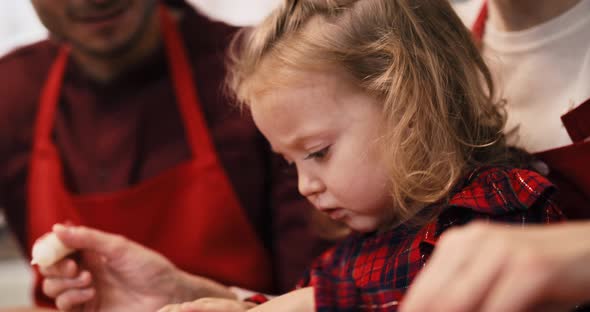 Handheld view of family baking cookies for Christmas