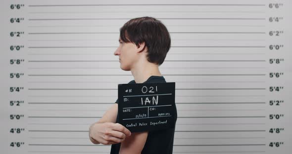 Profile Mugshot of Male Person with Dark Hair Turning to Different Sides and Looking to Camera