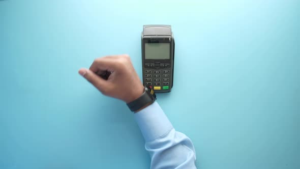 Contactless Payment Concept with Young Man Paying with Smart Watch