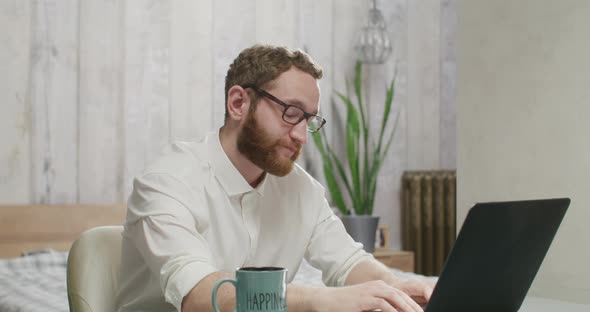 Tired Man Working at a Laptop Goes Crazy and Starts Dancing with Maracas