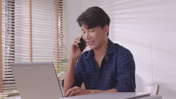 Asian businessman uses his smartphone to communicate.