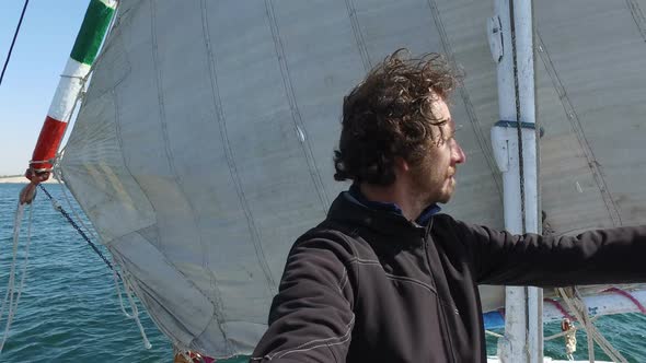 Male tourist standing on bow of felucca