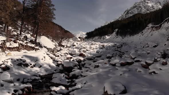 Winter Forest and Snowcapped River with a High Iron Content in Drifts of White Snow High in the