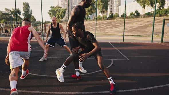 Closeknit Multiracial Team of Young Guys Play Basketball Professionally