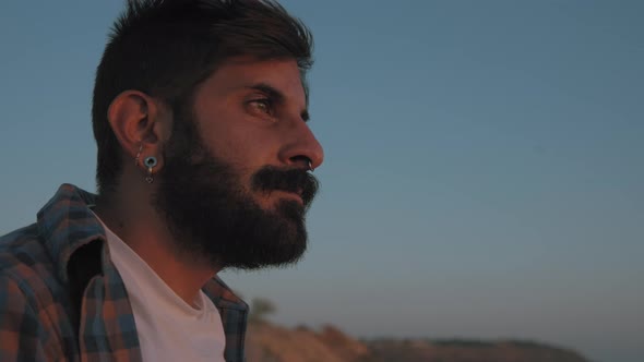 A mixed race man looking at sunset