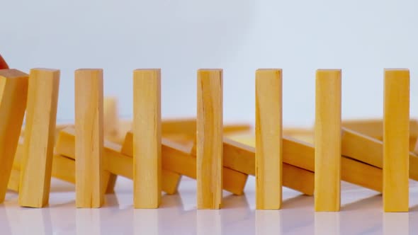 Domino Effect Row of Wooden Domino Falling Down on White Background