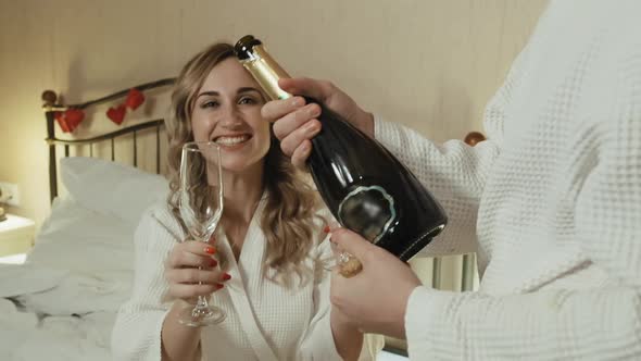 Young Couple in Bathrobes Celebrates Anniversary