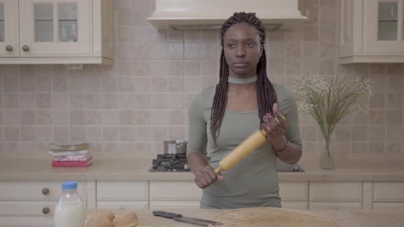 American African Beautiful Woman Standing with Rolling Pin and Thinking About Pie Preparing on the