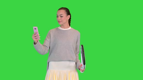 Pretty Young Female Tennis Player Using Smart Phone on a Green Screen Chroma Key