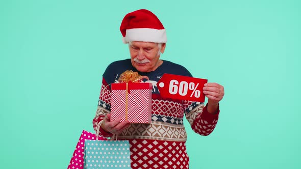 Grandfather in Christmas Sweater Showing Gift Box and 60 Percent Discount Inscriptions Banner Text