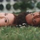 A young couple lying on the ground and looking at the camera - VideoHive Item for Sale