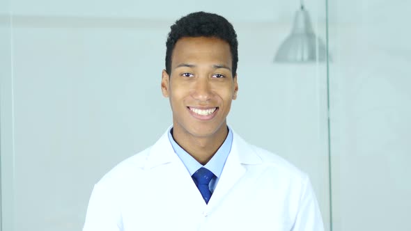 Smiling Relax Afro-American Doctor Sitting in Clinic