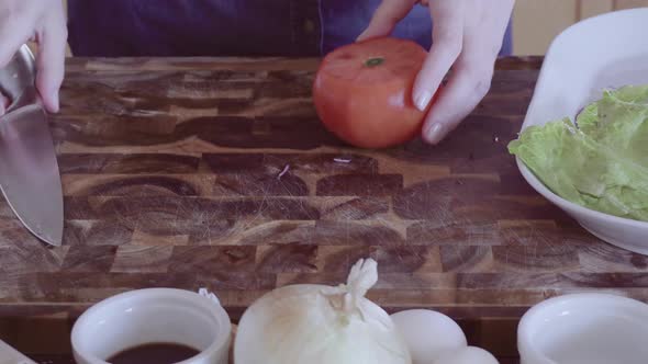 Slicing fresh organic vegetables for gourmet burger garnish