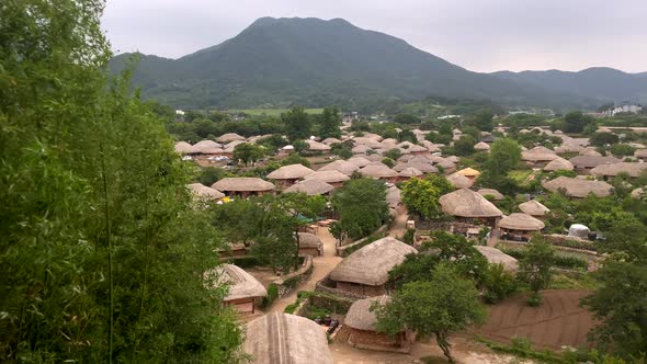 Aerial panorama shot of traditional village in South Korea in rural landscape with mountains during