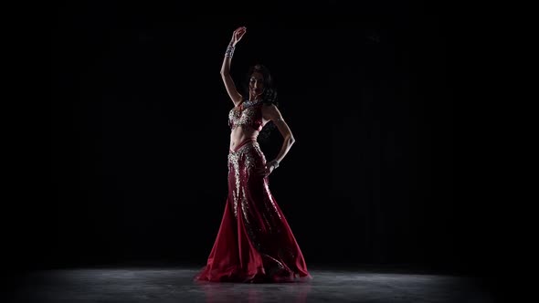 Belly Dancer Girl Continue Dance in Chiffon Dress . Black Background