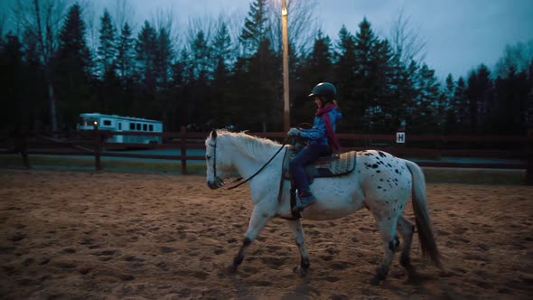 A Girl Riding Horse in a Beautiful Cloudy Evening