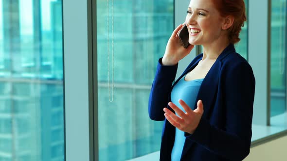 Female executive talking on mobile phone