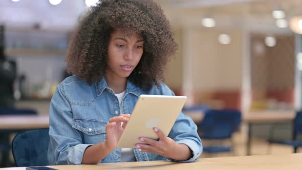 African Woman Upset By Loss on Tablet at Work