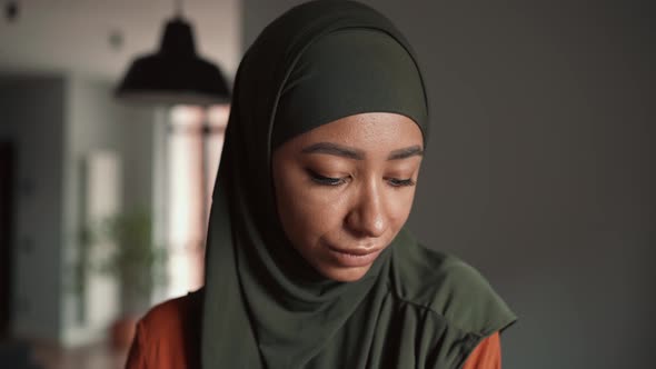 Happy Muslim woman wearing hijab looking at the camera