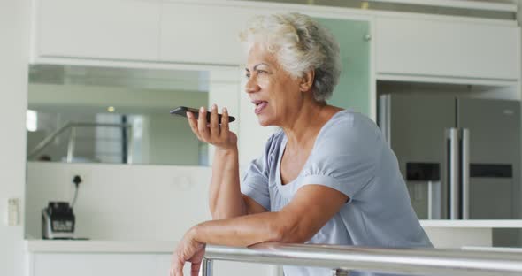 African american senior woman talking on smartphone at home